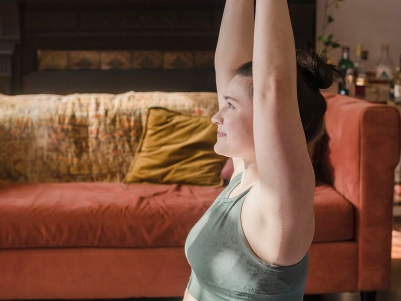 Person in a focused stance during a home workout session.